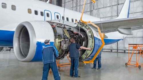 Assembling,,Replacing,Engine,Parts,Of,The,Plane,After,Repair.,Specialist Assembling, replacing engine parts of the plane after repair. Specialist mechanic controls the crane of an airplane. Concept maintenance of aircraft
